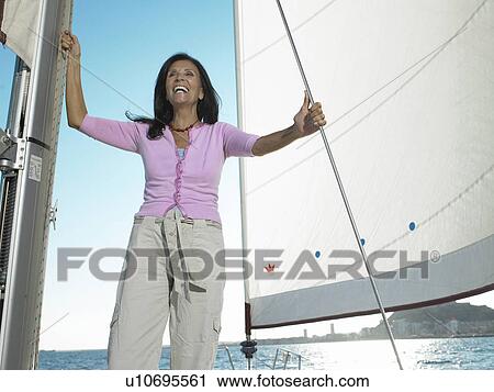 Mature woman standing on yacht, smiling View Large Photo Image Stock Image - Mature woman standing on yacht, smiling. Fotosearch