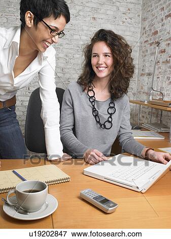 Two businesswomen laughing., Brussels, Belgium. View Large Photo Image Stock Photo - Two businesswomen laughing., Brussels, Belgium.. Fotosearch