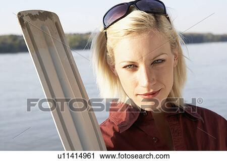 Woman holding an oar. View Large Photo Image Stock Image - Woman holding an oar.. Fotosearch