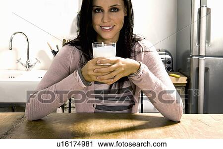 Woman holding glass of milk. View Large Photo Image Stock Image - Woman holding glass of milk.. Fotosearch