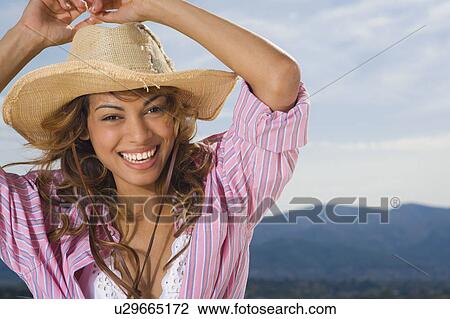Woman laughing and wearing a hat outdoors. View Large Photo Image Stock Image - Woman laughing and wearing a hat outdoors.. Fotosearch