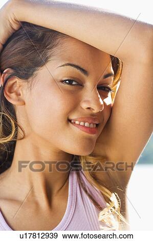 Stock Photo - Woman smiling outdoors.. Fotosearch
