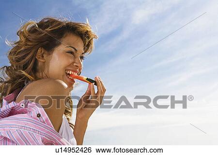 Woman with smile eats watermelon outside. View Large Photo Image Stock Photograph - Woman with smile eats watermelon outside.. Fotosearch