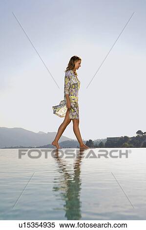 Stock Photography - Young woman by poolside.. Fotosearch