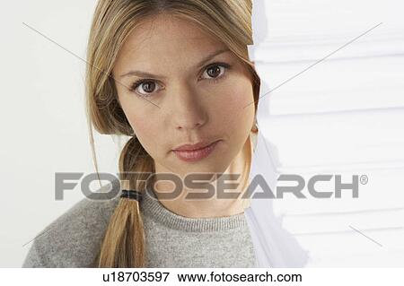Stock Photo - Young woman working from home with huge pile of paper.. Fotosearch