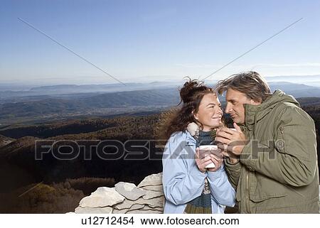 Picture - Couple having a hot drink.. Fotosearch