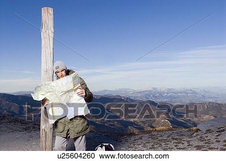Stock Image - Man looking at a map.. Fotosearch