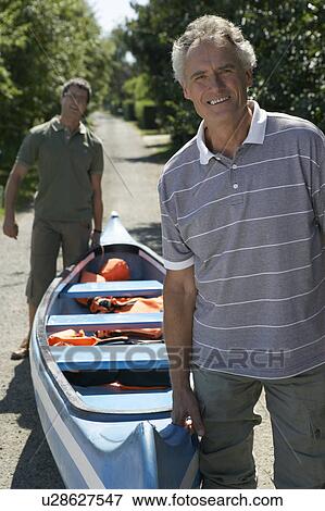 People on a path carrying a canoe. View Large Photo Image Stock Photo - People on a path carrying a canoe.. Fotosearch