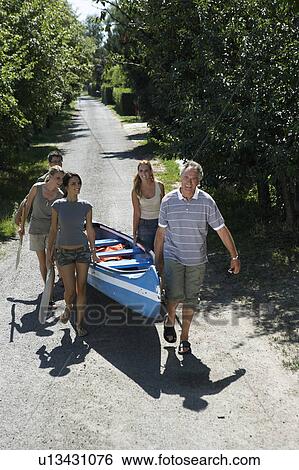 People on a path carrying a canoe. View Large Photo Image Stock Photograph - People on a path carrying a canoe.. Fotosearch
