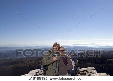 Portrait of a couple against mountains. View Large Photo Image Stock Photography - Portrait of a couple against mountains.. Fotosearch