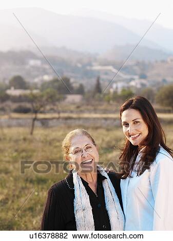 Senior mother and daughter in field, smiling, portrait View Large Photo Image Stock Image - Senior mother and daughter in field, smiling, portrait. Fotosearch