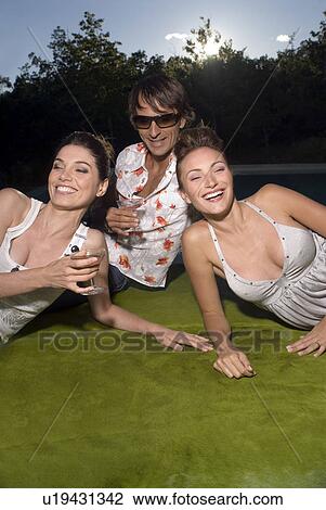 Three people on a blanket with drinks View Large Photo Image Stock Image - Three people on a blanket with drinks. Fotosearch