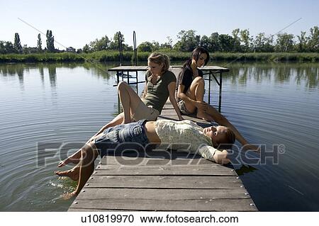 Three young women on a pier. View Large Photo Image Stock Image - Three young women on a pier.. Fotosearch