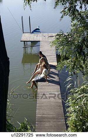 Stock Photography - Three young women on a pier.. Fotosearch