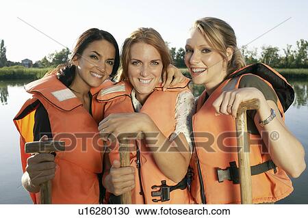 Three young women on a pier with oars. View Large Photo Image Stock Image - Three young women on a pier with oars.. Fotosearch