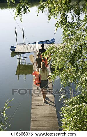 Three young women on a pier with oars. View Large Photo Image Stock Photography - Three young women on a pier with oars.. Fotosearch