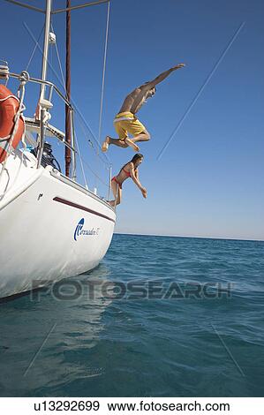 Young couple jumping off yacht into sea View Large Photo Image Stock Photo - Young couple jumping off yacht into sea. Fotosearch