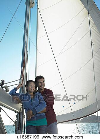 Young couple relaxing on yacht, smiling View Large Photo Image Stock Photograph - Young couple relaxing on yacht, smiling. Fotosearch