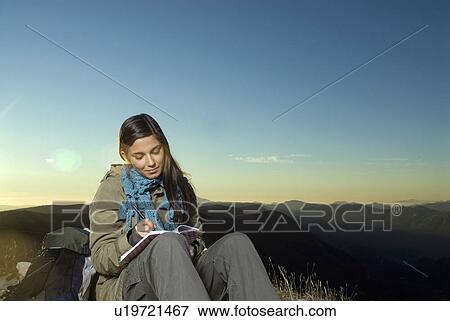 Young girl writing in her diary. View Large Photo Image Stock Photo - Young girl writing in her diary. . Fotosearch