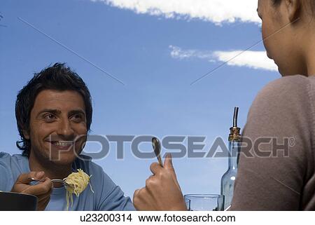 Young man eating pasta View Large Photo Image Picture - Young man eating pasta. Fotosearch