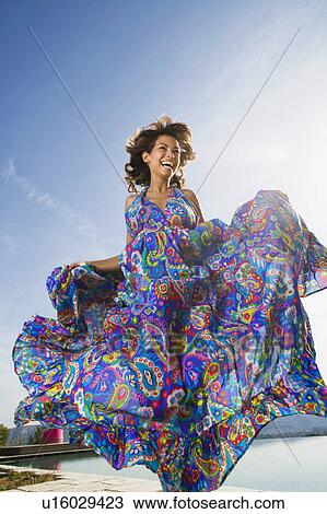 Dynamic beauty woman laughing outdoors in a colorful long summer dress. View Large Photo Image Stock Image - Dynamic beauty woman laughing outdoors in a colorful long summer dress.. Fotosearch