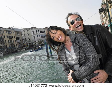 Laughing couple embracing near Rialto Bridge. Venice, Italy. View Large Photo Image Stock Image - Laughing couple embracing near Rialto Bridge. Venice, Italy.. Fotosearch
