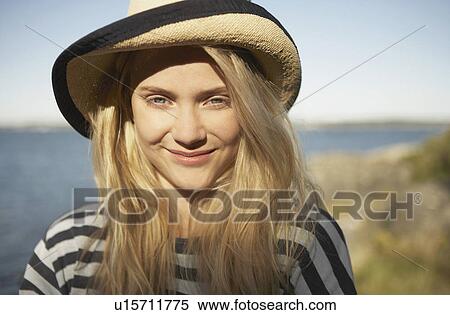 Stock Photography - Portrait of young woman straw sun hat.. Fotosearch