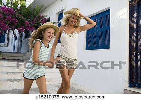 Woman and young girl running outside house smiling. View Large Photo Image Stock Photography - Woman and young girl running outside house smiling.. Fotosearch