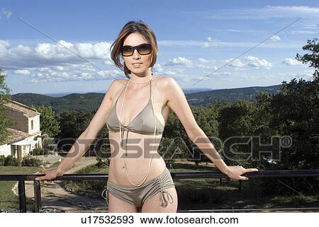 Woman standing outdoors in a bikini View Large Photo Image Stock Image - Woman standing outdoors in a bikini. Fotosearch