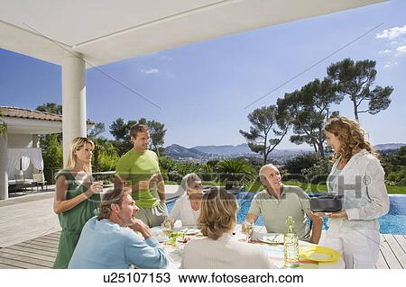 Family eating by poolside. View Large Photo Image Stock Image - Family eating by poolside.. Fotosearch