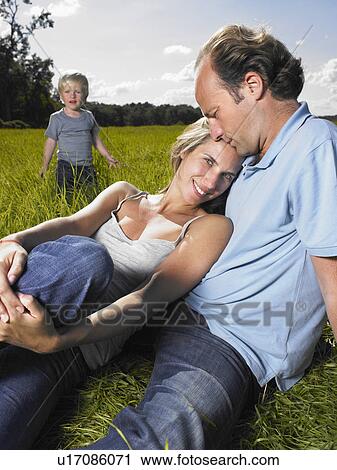 Family enjoying a good time in a field. View Large Photo Image Stock Image - Family enjoying a good time in a field.. Fotosearch