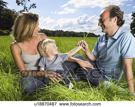 Stock Photo - Family enjoying a good time in a field.. Fotosearch
