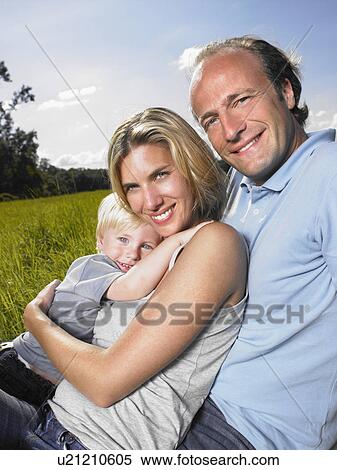 Stock Photography - Family enjoying a good time in a field.. Fotosearch