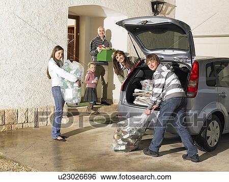 Family loading car boot with recycling, smiling, portrait View Large Photo Image Stock Photograph - Family loading car boot with recycling, smiling, portrait. Fotosearch