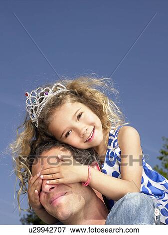 Man with smiling young girl wearing tiara on shoulders. View Large Photo Image Stock Photo - Man with smiling young girl wearing tiara on shoulders.. Fotosearch