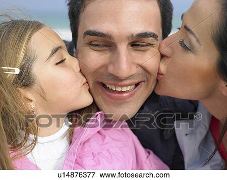 Mother and daughter (6-8) kissing father from each side. Alicante, Spain. View Large Photo Image Stock Photo - Mother and daughter (6-8) kissing father from each side. Alicante, Spain.. Fotosearch
