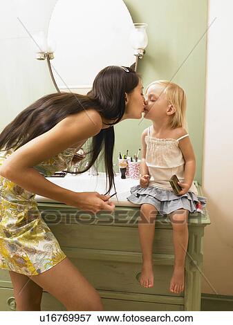 Mother and daughter kissing. Stock Photo | u16769957 | Fotosearch