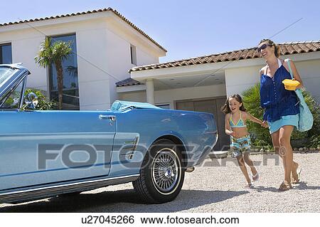 Stock Photograph - Mother and daughter leaving home.. Fotosearch