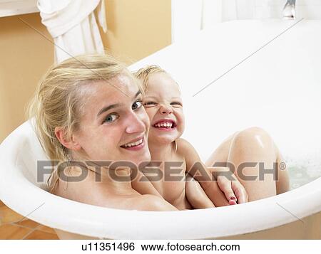 Stock Photograph - Mother and daughter taking a bath.. Fotosearch