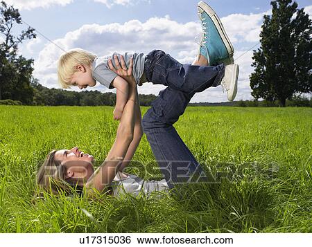Mother and son playing in a field. View Large Photo Image Stock Photograph - Mother and son playing in a field.. Fotosearch