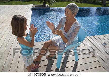 Stock Photography - Older woman playing with young girl.. Fotosearch