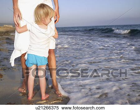 Woman standing with a young girl at the beach. View Large Photo Image Stock Photography - Woman standing with a young girl at the beach.. Fotosearch