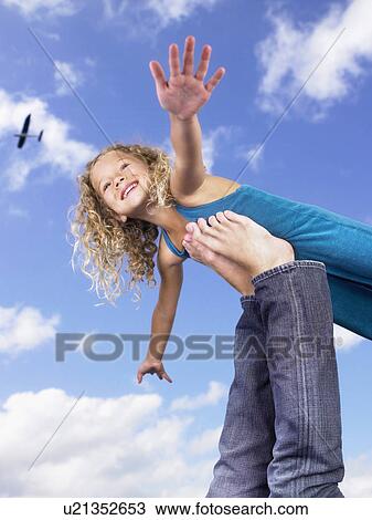 Stock Image - Young girl swirling feet in the air.. Fotosearch