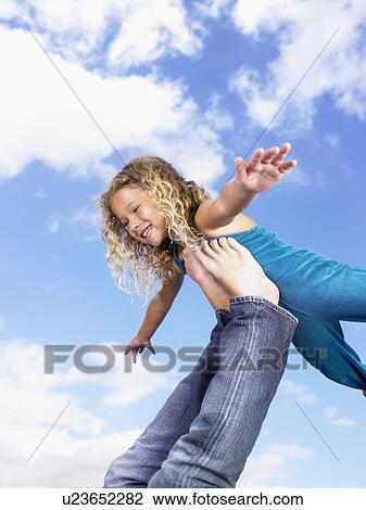 Young girl swirling feet in the air. View Large Photo Image Stock Image - Young girl swirling feet in the air.. Fotosearch