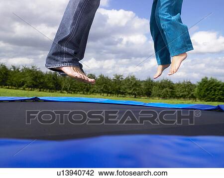 Stock Image - Young girl's feet father's feet.. Fotosearch