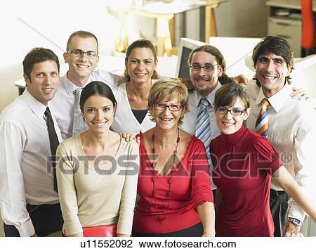 Stock Image - Staff standing together in a group. Fotosearch