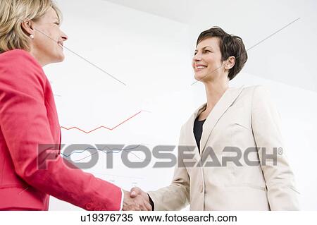 Two women handshaking View Large Photo Image Stock Photography - Two women handshaking. Fotosearch