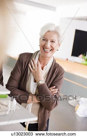 Woman at a architecture model, smiling View Large Photo Image Stock Image - Woman at a architecture model, smiling. Fotosearch