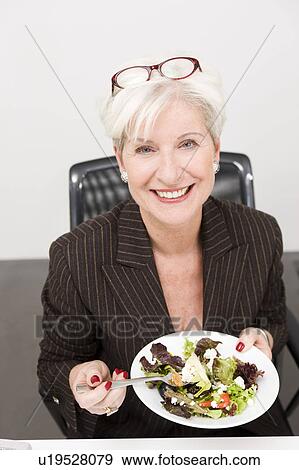 Woman eating salad View Large Photo Image Stock Photo - Woman eating salad . Fotosearch