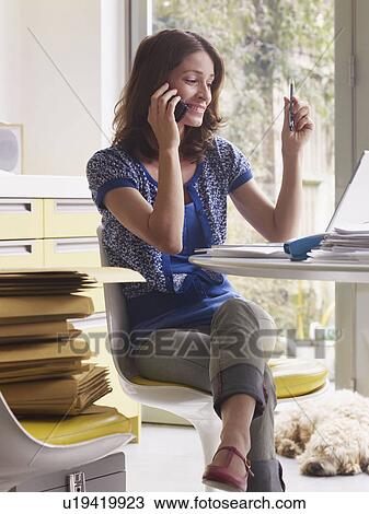 Woman running business at kitchen table View Large Photo Image Stock Image - Woman running business at kitchen table. Fotosearch